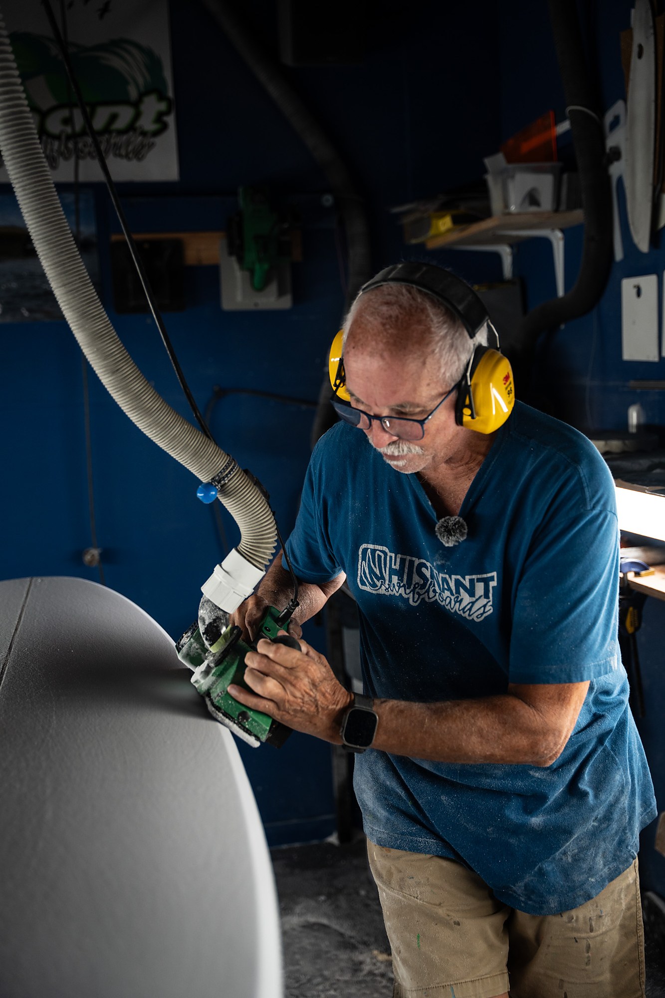 Mike Whisnant planing the rail of a midlength, dust hose overhead