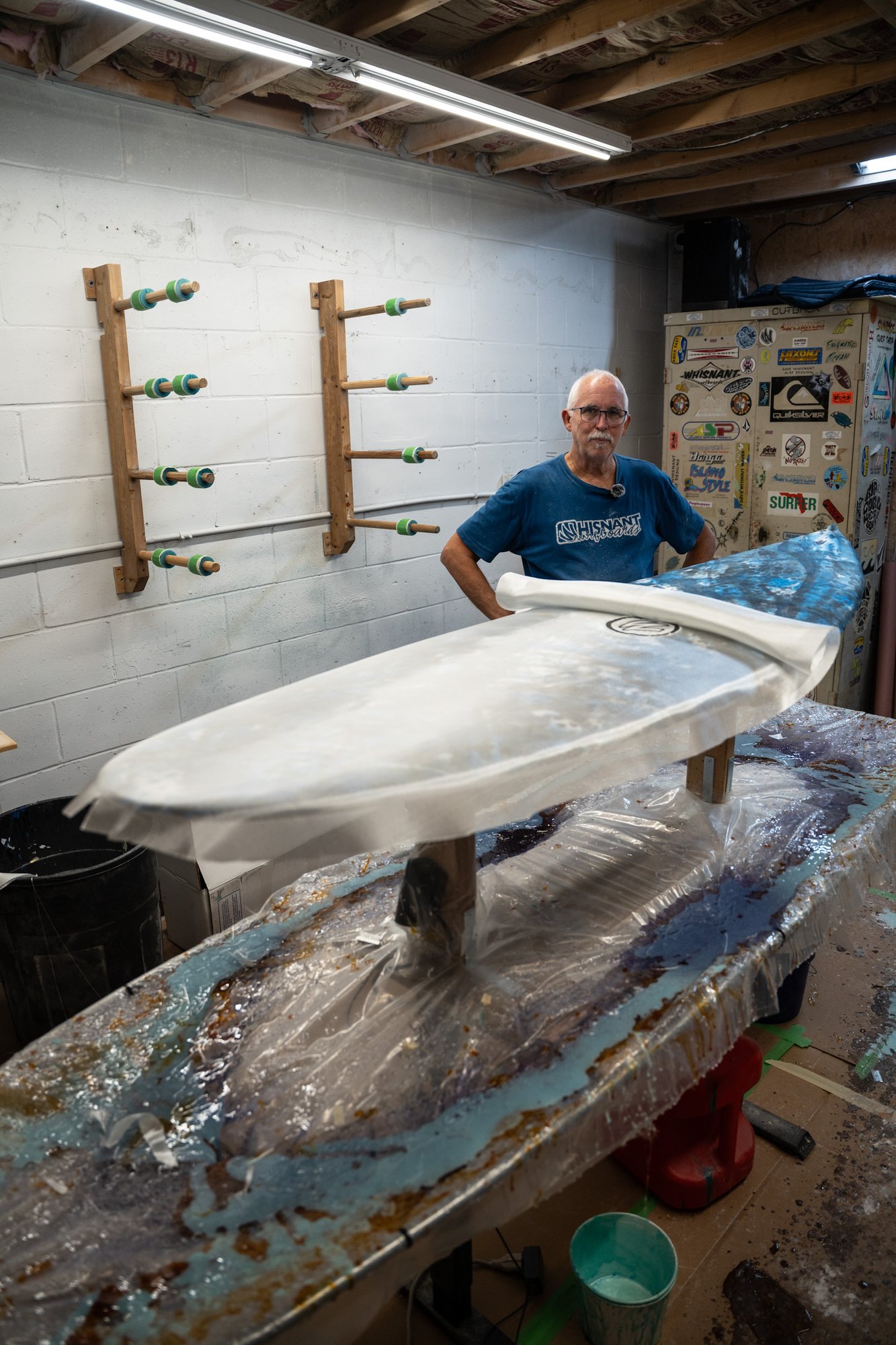 Mike Whisnant in his shaping bay behind a freshly glassed board