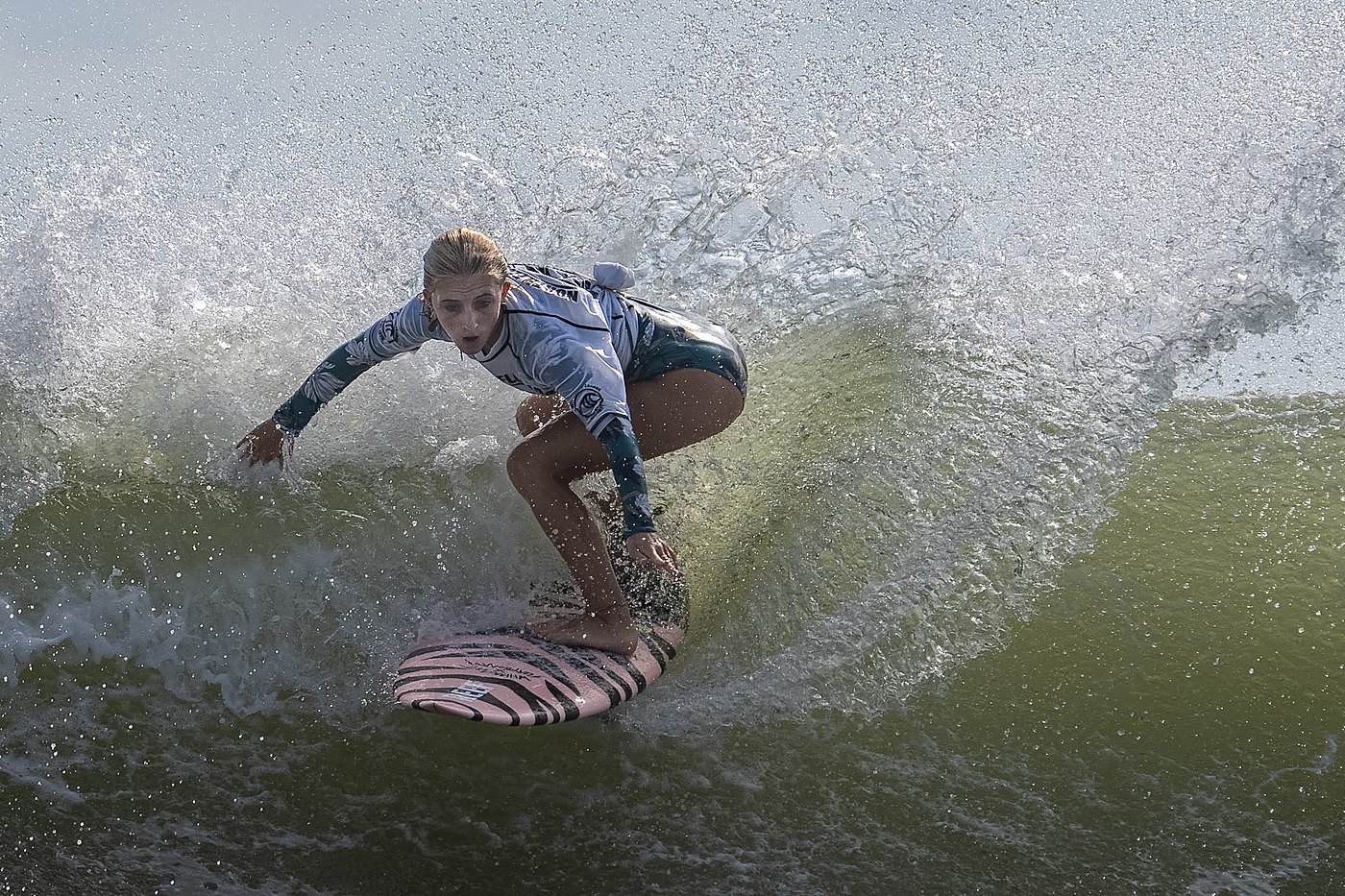 Surfer turning inside a bowl of backlit spray