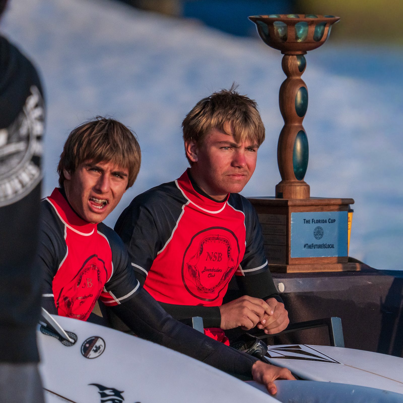 Two young surfers beside the Florida Cup trophy