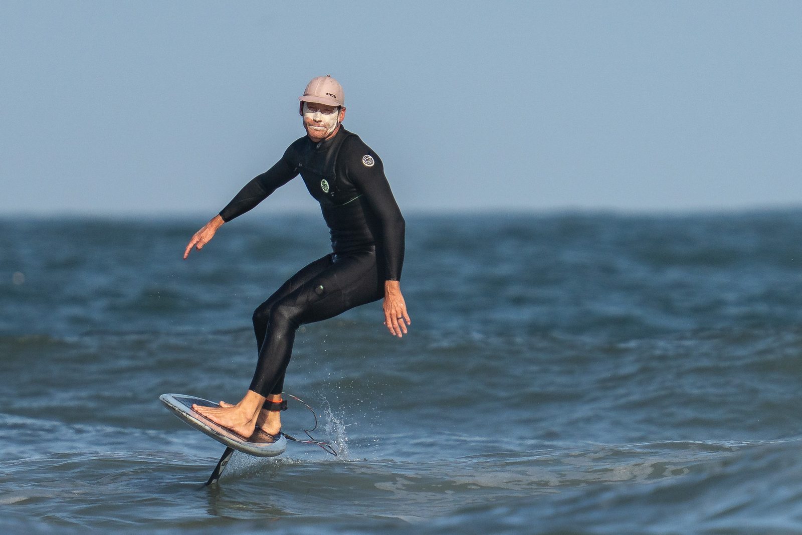 A foil surfer glides above the water on Florida's First Coast