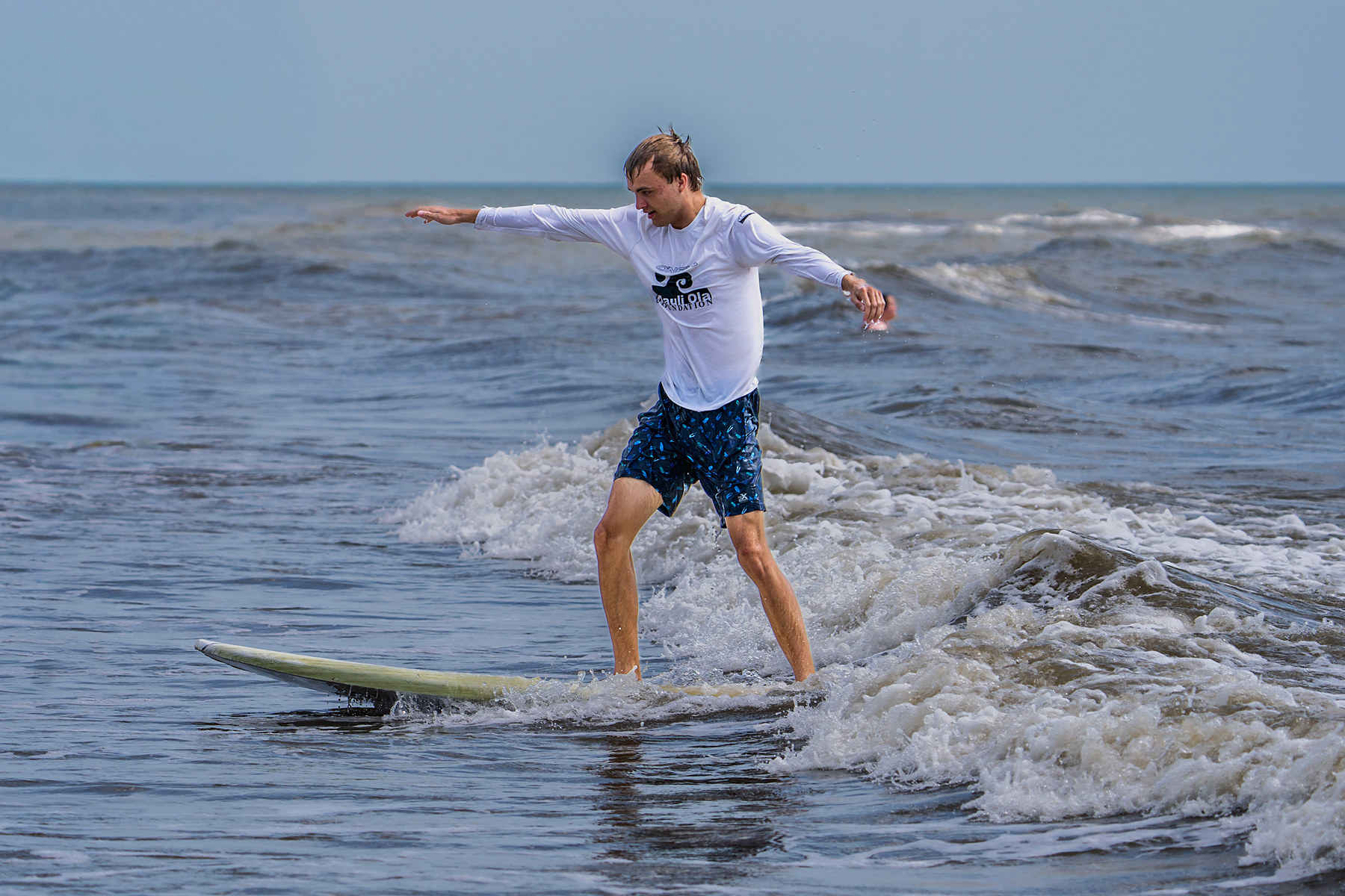 A surfer on his own wave, no volunteer in the frame.