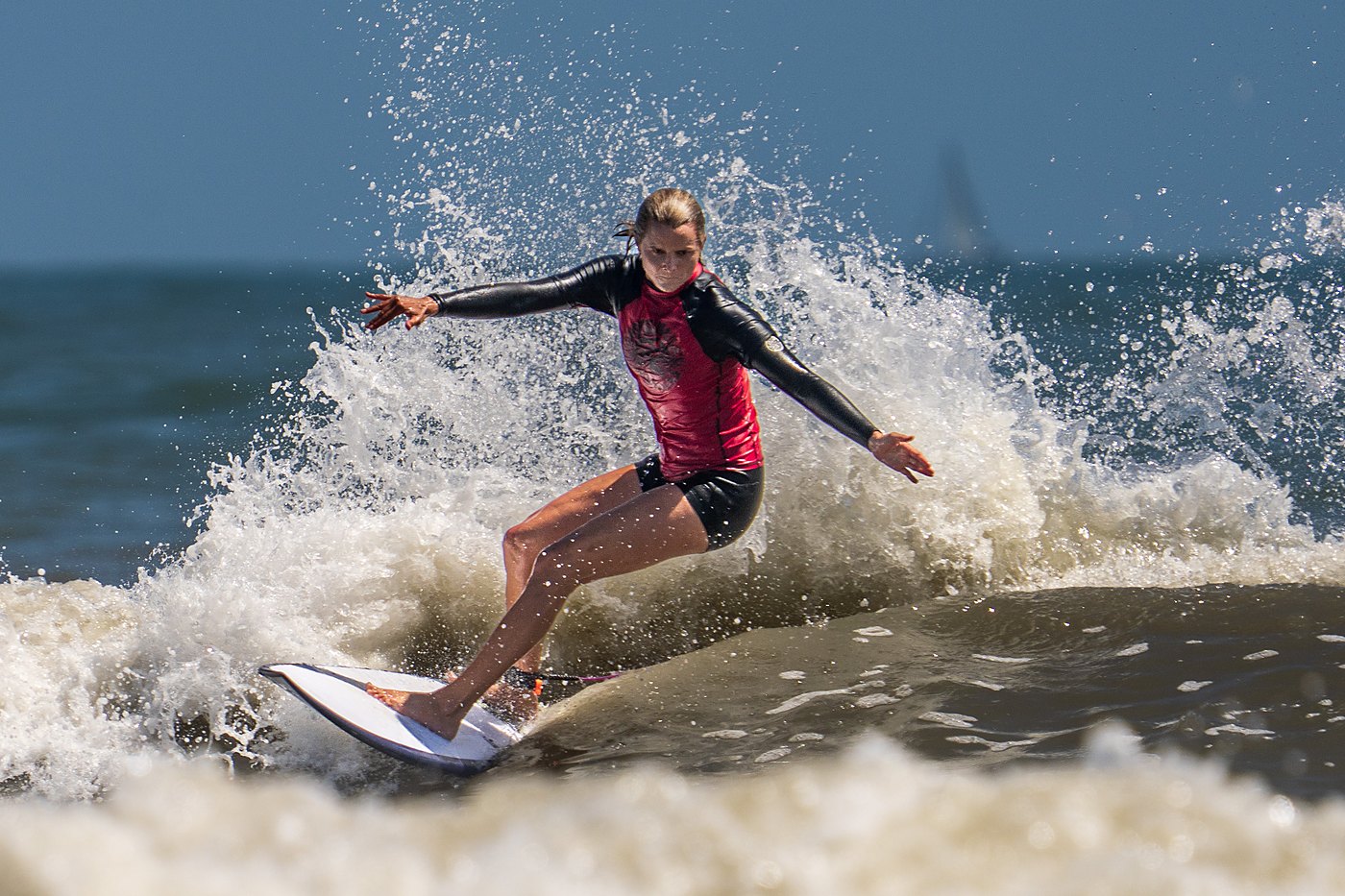 Surfer driving through a powerful top turn